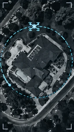 A drone view from above circling a house with a pool, the orbit path drawn as a dashed ring.